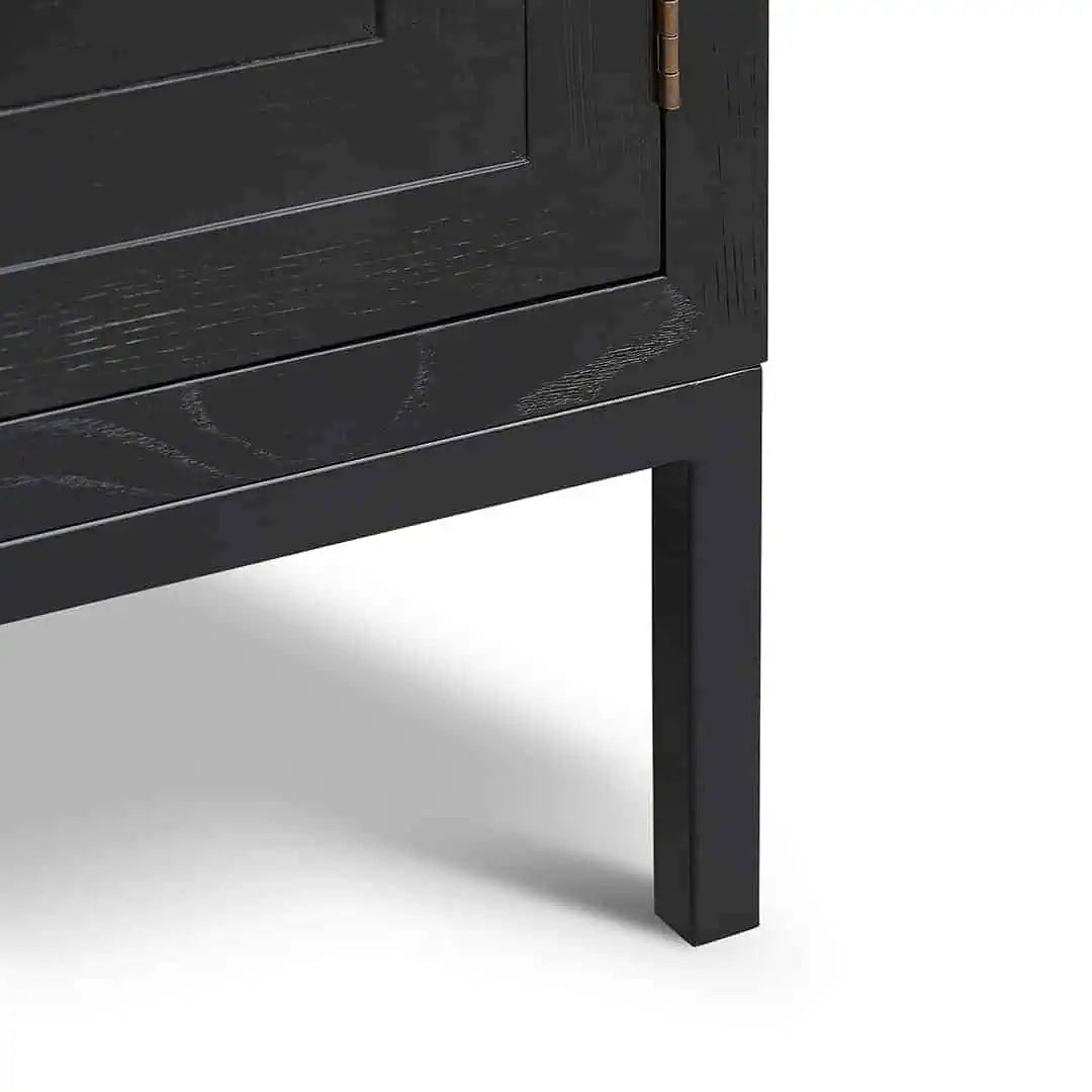 Close-up of a black wooden cabinet leg on a white background