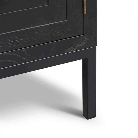 Close-up of a black wooden cabinet leg on a white background