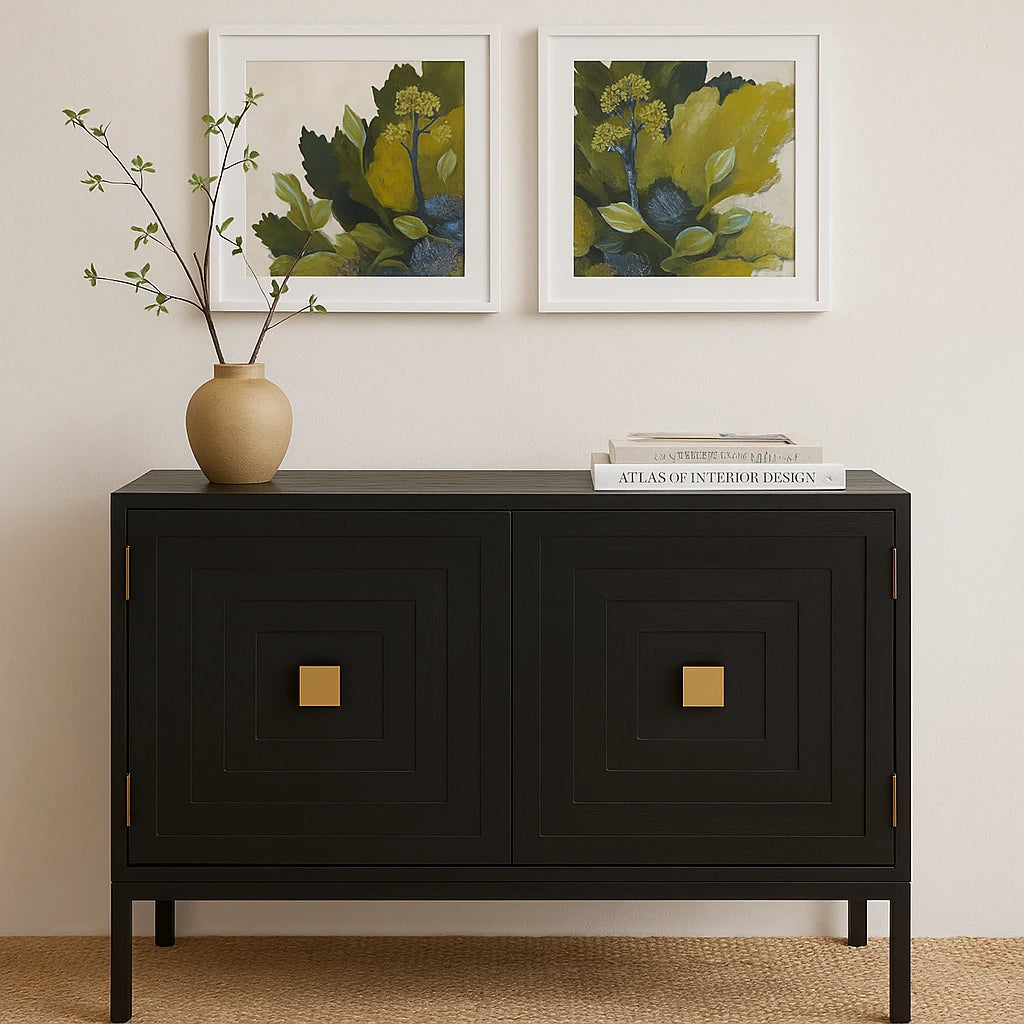 Black cabinet with gold accents in a room with framed artwork and a vase.