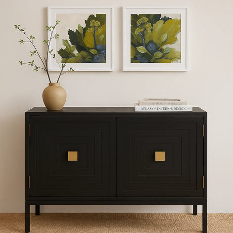 Black cabinet with gold accents in a room with framed artwork and a vase.