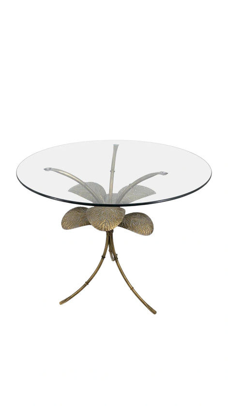 Front view of the Amari Side Table displaying its symmetrical leaf design and refined gold finish beneath a clear glass surface.