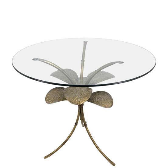 Front view of the Amari Side Table displaying its symmetrical leaf design and refined gold finish beneath a clear glass surface.