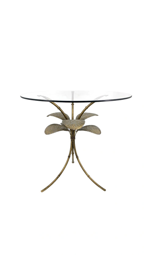 Side view of the Amari Gold Leaf Side Table showcasing its sculptural iron base with intricate leaf detailing and glass top.