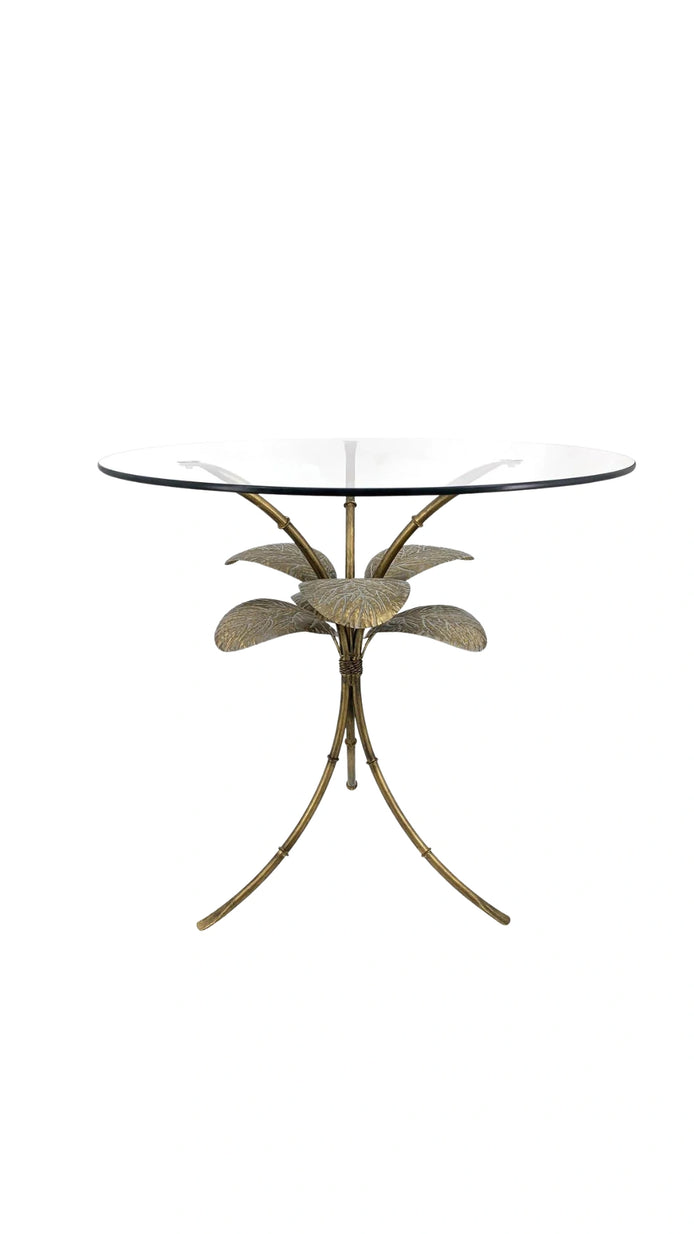 Side view of the Amari Gold Leaf Side Table showcasing its sculptural iron base with intricate leaf detailing and glass top.