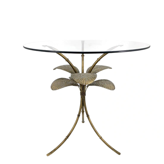 Side view of the Amari Gold Leaf Side Table showcasing its sculptural iron base with intricate leaf detailing and glass top.