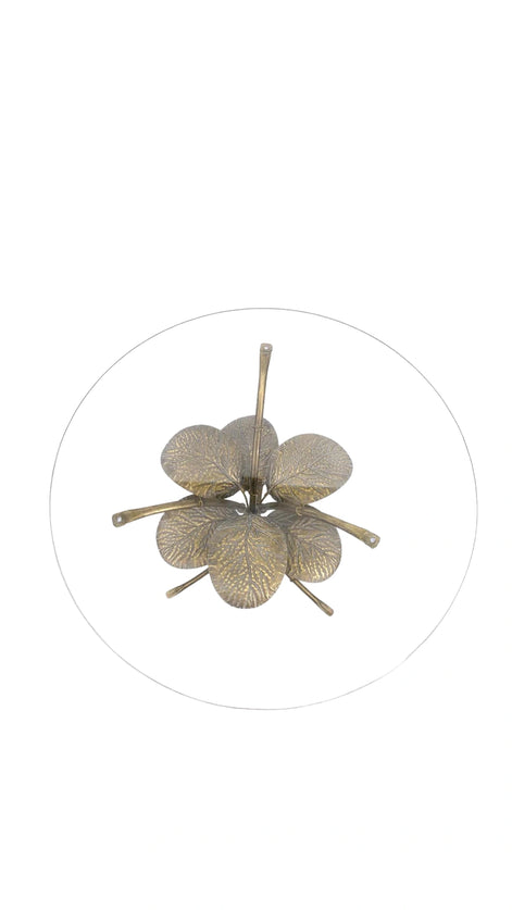 Top view of the Amari Gold Leaf Side Table showcasing its sculptural iron base with intricate leaf detailing and glass top