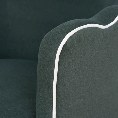 Close-up of a dark green cushion with a white line on a black background