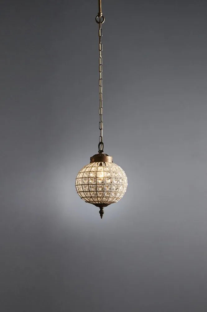 Decorative pendant light with crystal details on a gray background