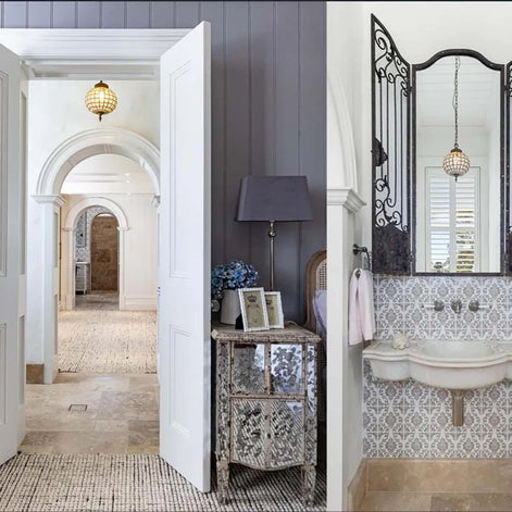Bathroom interior with patterned tiles, mirror, and decorative elements.