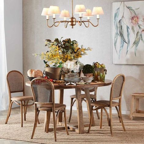 Elegant Prescot 6 arm chandelier crafted from solid brass with adjustable hanging rods haning over a styled dining setting
