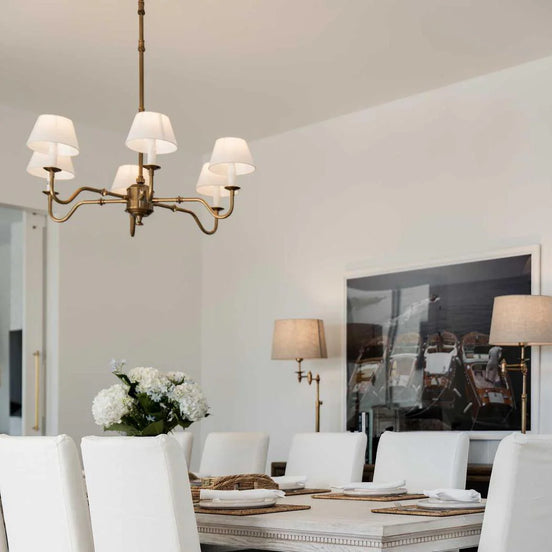Dining room with a chandelier, table, chairs, and decorative elements.