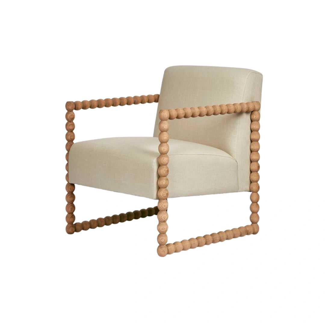 Beige armchair with wooden bead frame on a white background